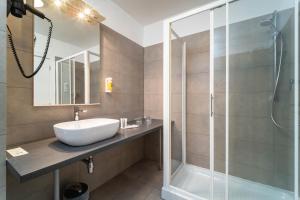 a bathroom with a sink and a shower at Hotel Plaza in Pag +83 photos