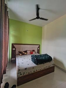 a bed in a room with a ceiling fan at Heera Hotel& Restaurant in Gupta Kāshi