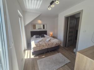 a bedroom with a bed in a white room at Domki California in Jastrzębia Góra