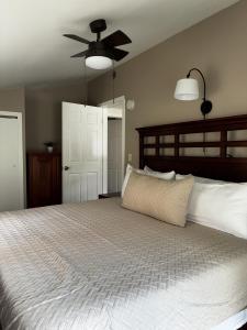 a bedroom with a large bed and a ceiling fan at Killington/ Rutland 2 bedroom Cabin, cabin #4 in Killington