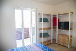 a bedroom with a room with a bed and a window at Umbra Living in Bastia Umbra