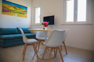 a living room with a table and chairs and a couch at Umbra Living in Bastia Umbra