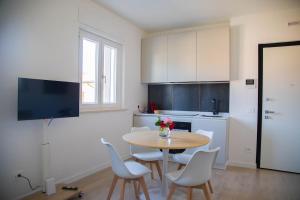 a kitchen with a table and chairs in a room at Umbra Living in Bastia Umbra