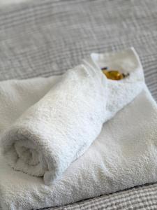 a pile of white towels sitting on a bed at Uferglanz - Balcony, view, sparkling wine, snacks in Koblenz +20 photos