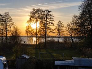 a sunset over a field with a soccer ball at Ferienwohnungen Dümmersee - Hexenhaus in Hüde