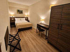 a hotel room with a bed and a desk and a bed and a desk at Apart Home Tel AHT in Krapkowice +10 photos