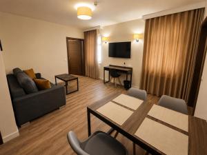 a living room with a table and a couch at Apart Home Tel AHT in Krapkowice