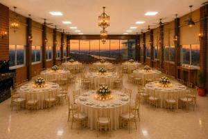 a banquet hall with tables and chairs with flowers on them at Country Inn Rishikesh at Laxman Jhula in Rishīkesh