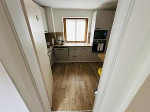 a kitchen with wooden floors and a window at Ferienhaus Ma-inz in Stadl an der Mur +13 photos