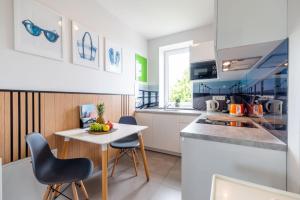 a kitchen with a small table and chairs in a room at Villa Baltica II in Rewa