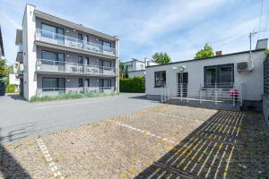 an empty parking lot in front of a building at Villa Baltica II in Rewa