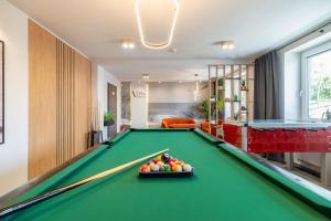 a billiard room with a pool table with a bowl of balls at Villa Baltica II in Rewa