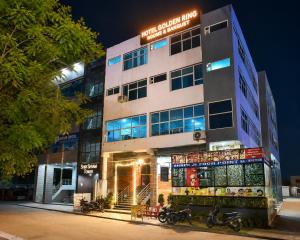 a building with motorcycles parked in front of it at Hotel Golden Ring in Lucknow