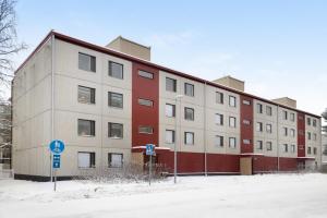 a large building with red and white at Central Lapland Apartment By Lapland Host in Rovaniemi