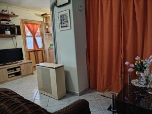 a living room with a couch and a television at Horváth kuckó in Fonyód