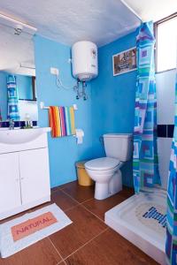 a blue bathroom with a toilet and a sink at Casitas Manuel in El Paso +38 photos