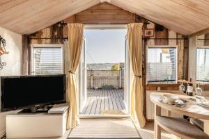 a living room with a tv and a large window at 1 Bed in Totnes oc-bc1000 in Totnes