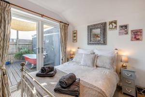 a bedroom with a bed and a balcony with a tub at 1 Bed in Totnes oc-bc1000 in Totnes