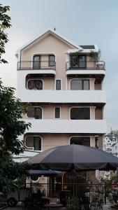 a large building with an umbrella in front of it at CozyhomeDaLat in Khu Chi Lăng