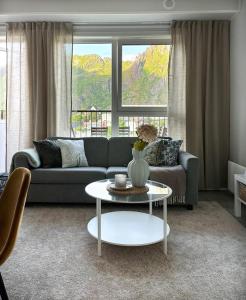 a living room with a couch and a table at Mountain and Sea View Svolvær in Svolvær