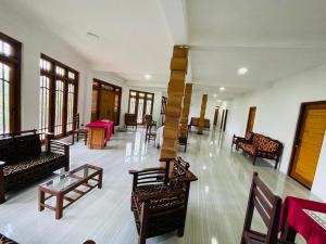 a large room with chairs and tables and a table at Archwey Coco Ella in Ella