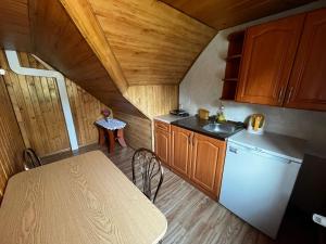 a small kitchen with a table and a sink at POKOJE GOŚCINNE U ANIELI Szczyrk Biały Krzyż in Szczyrk