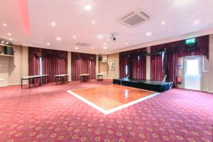 a ballroom with a table and a dance floor at Bournemouth Carlton Hotel By Sunday in Bournemouth +86 photos