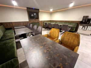 a dining room with a table and chairs at Apart Home Tel AHT in Krapkowice