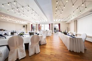 a banquet hall with white tables and chairs at Best Western Hotel Heide in Oldenburg +132 photos