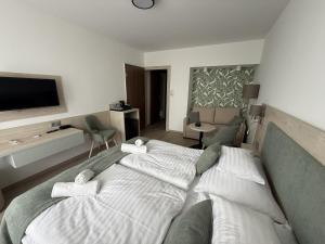 a bedroom with a large bed and a living room at Apartman Hotel in Bük