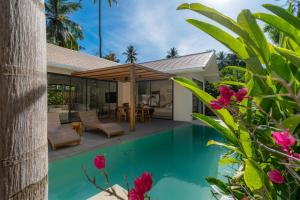 a villa with a swimming pool and a house at K Villas Phangan 01 in Thong Sala