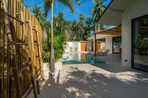 an external view of a villa with a swimming pool at K Villas Phangan 01 in Thong Sala
