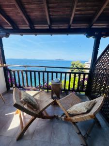a balcony with chairs and a view of the ocean at Hotel marmaras in Neos Marmaras