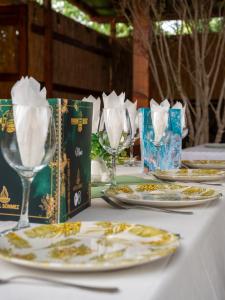 a table with plates and wine glasses on it at Hotel Boutique Casa Venusian in Venus