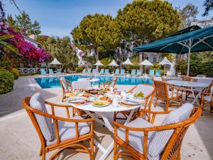 a table and chairs next to a swimming pool at Moonshine Hotel Suites in Bodrum City
