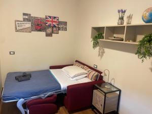 a small bedroom with a bed and a side table at Suites Asia in Argelato