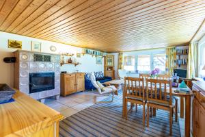 a kitchen with a table and chairs and a dining room at Haus Ottomar in Wieck