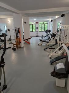 a gym with treadmills and machines in a room at Hotel Deyanira in Gorno Dryanovo