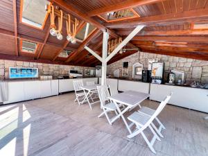 a kitchen with white chairs and a table and a counter at Moonshine Hotel Suites in Bodrum City