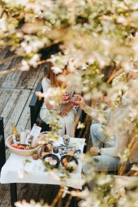 a group of people sitting around a table with food at L'Al-Golette by Curtis in Namur +8 photos