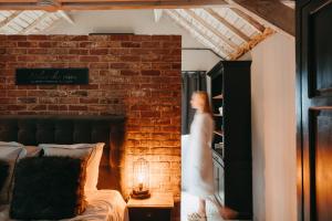 a woman in a white dress standing in a bedroom at L'Al-Golette by Curtis in Namur