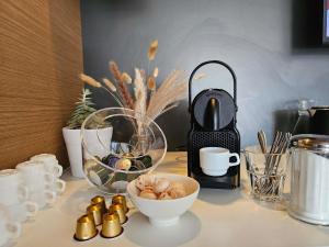 a counter top with a bowl of food and a vase at ibis Vesoul in Vesoul +75 photos