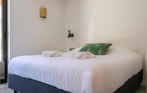 a bedroom with a large white bed with towels on it at De Rode Vos - Enjoyment in the forest in Giethmen +38 photos