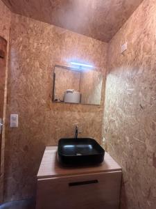 a bathroom with a black sink and a mirror at Domaine Solio - Lodge isolée, nature, animaux in Satillieu +29 photos