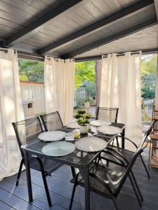 a black table and chairs on a porch at Holiday Home Orsag in Drage