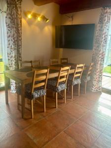 a conference room with a table and chairs and a screen at Králíkárna in Králíky