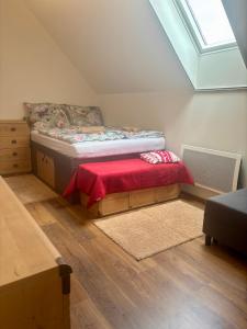 a bedroom with a bed with a red blanket at Králíkárna in Králíky