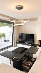 a living room with a black table and a television at Casa di Jiovanni Luxury in Asgourou