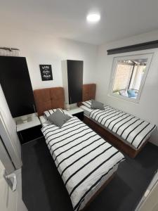 two beds sitting in a room with a window at Holiday Home Orsag in Drage +43 photos