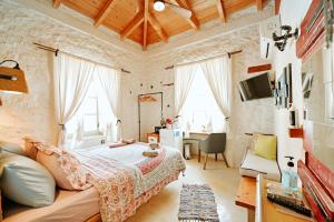 a bedroom with a bed and a desk in a room at Mastoris Mansion in Hydra